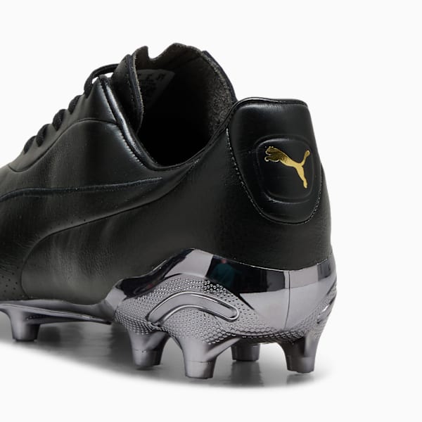 Black PUMA football boot featuring silver soleplate and gold logo detail.