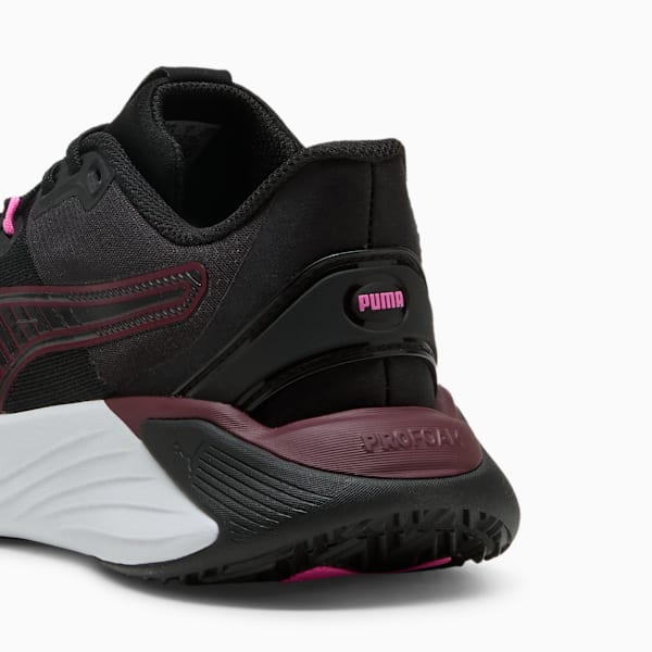 Black PUMA women's trainer with burgundy accents and a white sole.