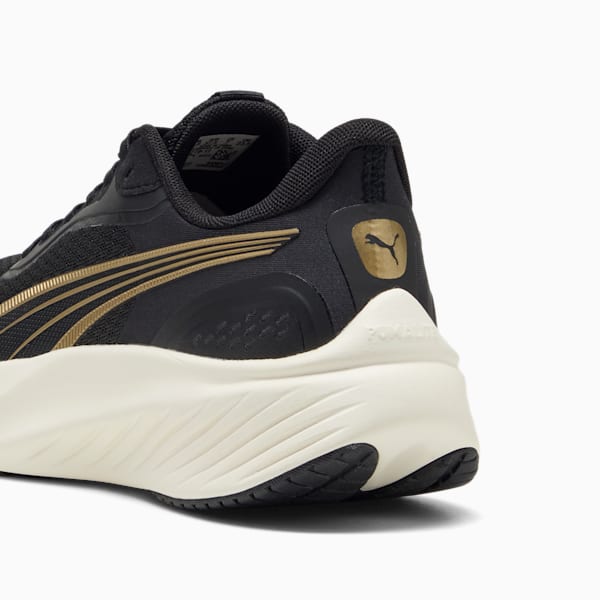 Black PUMA running shoe with gold stripes and a cream-coloured sole.