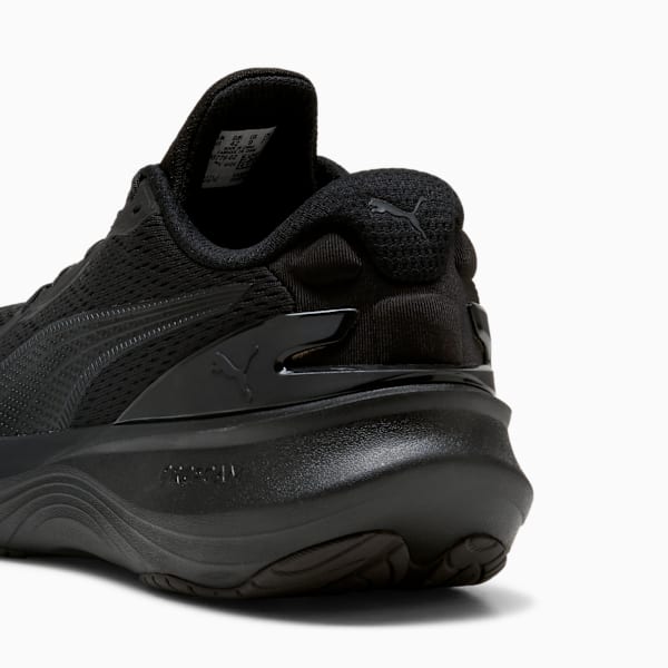 Black PUMA trainers, adult, featuring a supportive heel and subtle logo detailing.