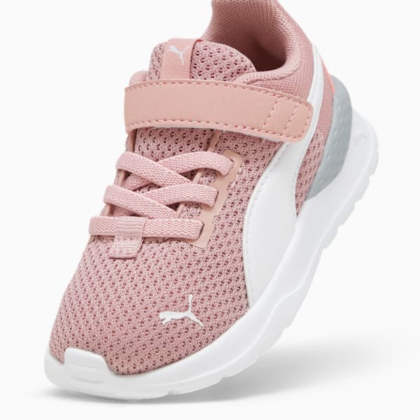 Pink PUMA trainer for toddlers, featuring laces and a touch-fastening strap.