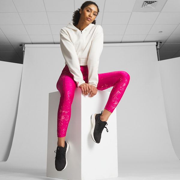 Woman in white tights and sneakers on gray background Stock