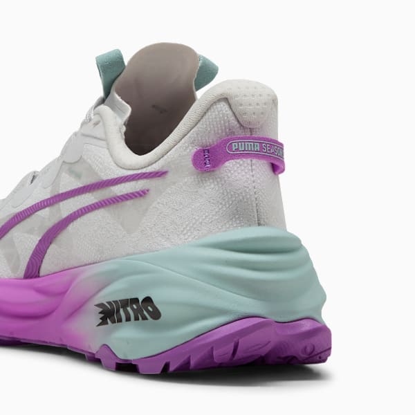 White PUMA trainer, with purple stripes and light blue/purple sole, showing 'NITRO' text.