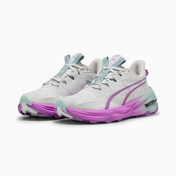 White PUMA trainers with lilac sole and teal accents.
