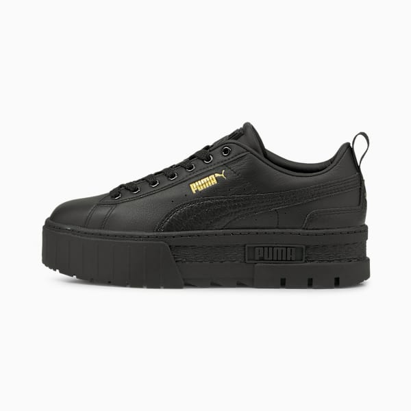 Black PUMA women's trainer with a thick, textured sole and gold logo detail.