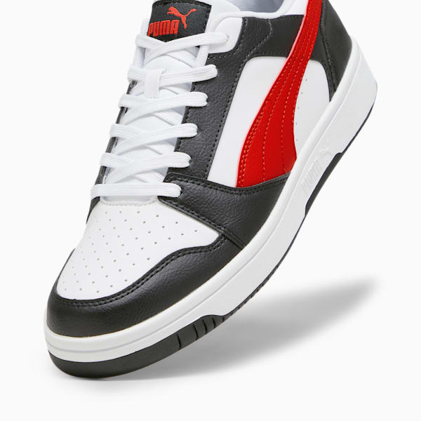 White, black and red PUMA trainer with a smooth leather-like upper.