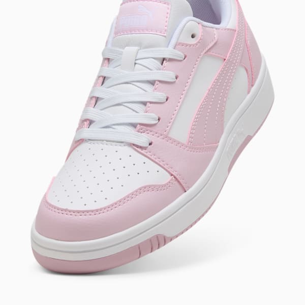 Pink PUMA trainers for adults, with white accents and lace-up fastening.
