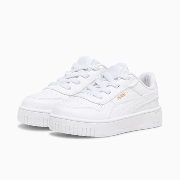 White PUMA trainers for kids, featuring a lace-up design and rubber sole.