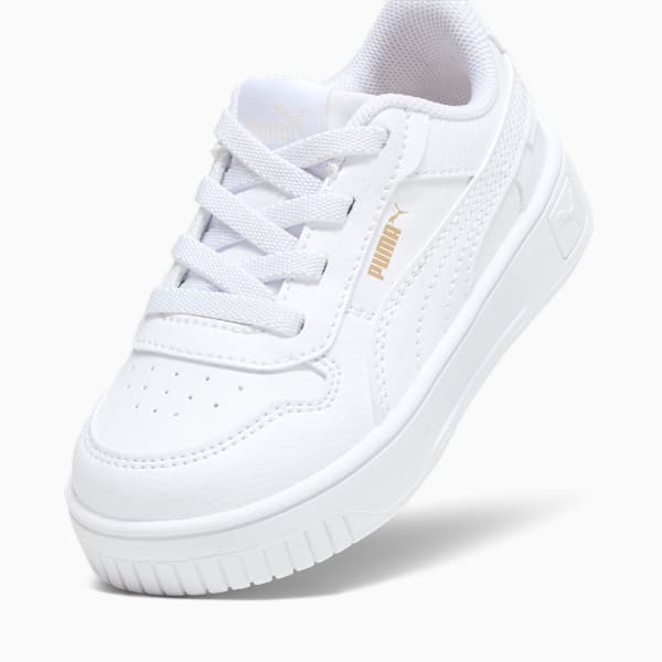 White PUMA trainer for kids, featuring a lace-up design and a durable rubber sole.