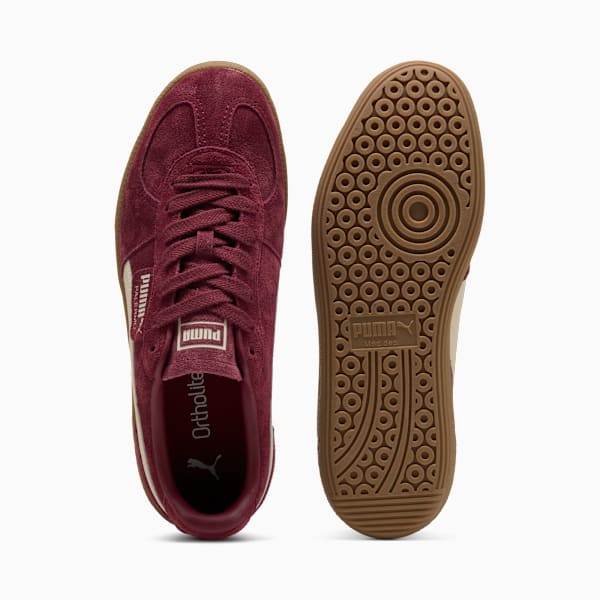 Burgundy PUMA trainer showing laces and sole with circular grip pattern for adults.