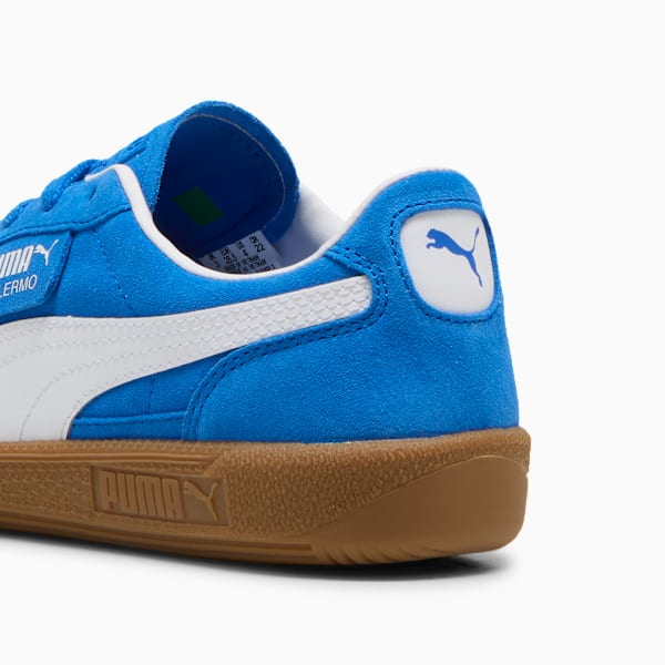 Blue PUMA Palermo trainers featuring a white stripe and brown sole, for adults.