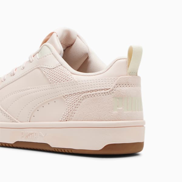 Peach PUMA trainers for adults, featuring a textured finish and low profile sole.