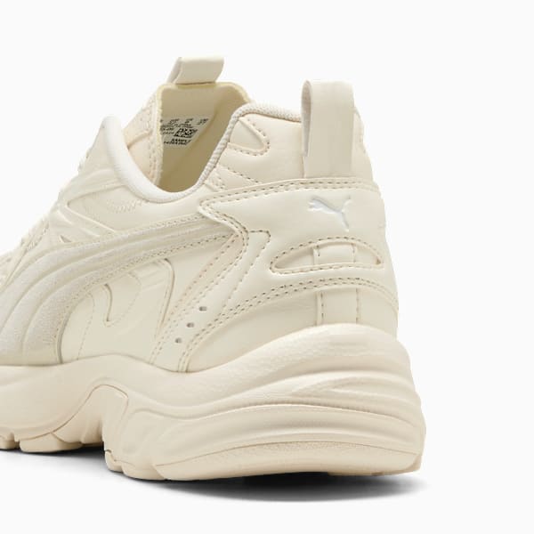 Cream PUMA women's trainer with layered design and a cushioned, chunky sole.