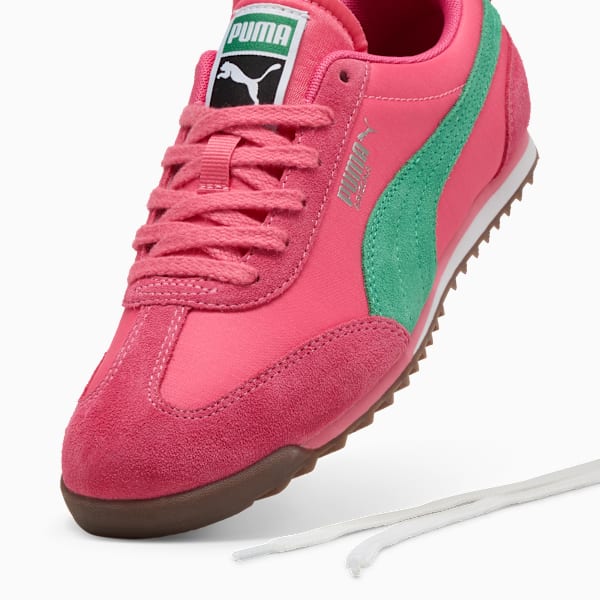 Pink PUMA trainer with green stripe and suede accents for women.