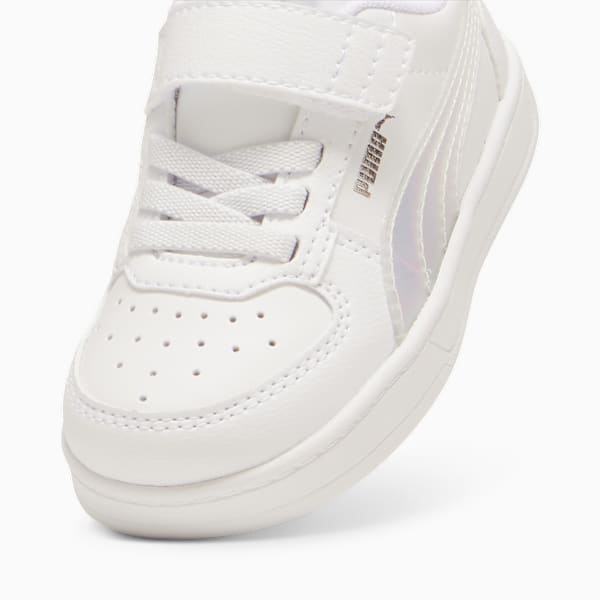 Close-up of a white PUMA trainer for kids with laces and hook-and-loop fastener.