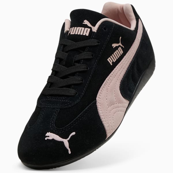 Black PUMA trainer with pink accents, laces, and suede-like material.