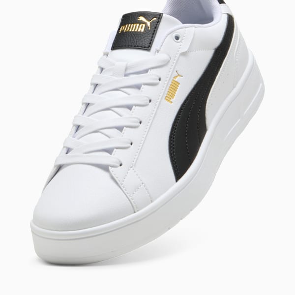 White PUMA trainers with black stripe and lace-up fastening for adults.