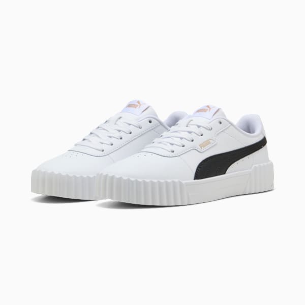 White PUMA trainers for women, with a black stripe and a textured white sole.