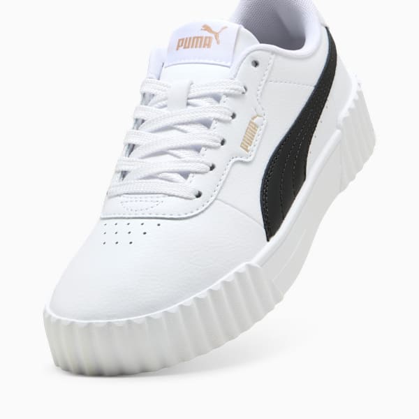 White PUMA trainer for women, featuring black stripe and ridged sole.