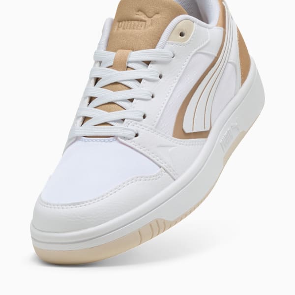 White PUMA trainers for adults with tan details and lace-up fastening.