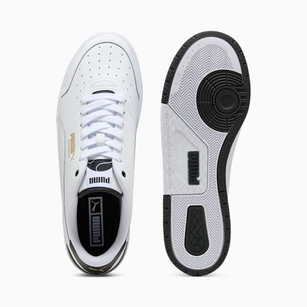 White PUMA adult trainer showing laces and sole with black detailing.