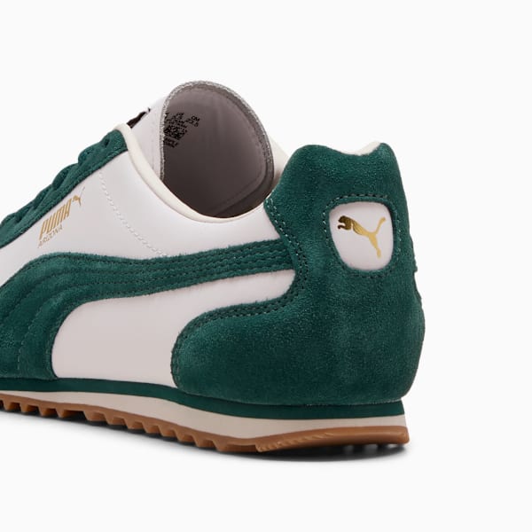 Green PUMA trainers, adult, with white leather and gold logo detailing.