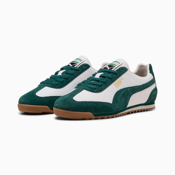 Green PUMA Arizona trainers with white leather accents and a brown sole.