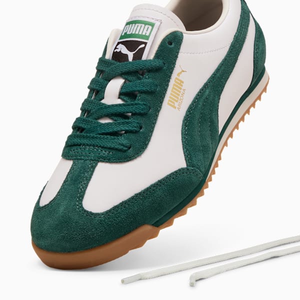 Green PUMA trainers with white leather and suede details for any gender.