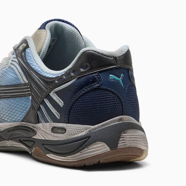 Blue PUMA trainers with a mesh design and layered sole for adults.