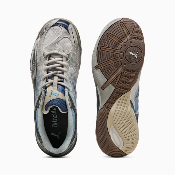 Silver PUMA trainers with a patterned brown sole and blue and beige accents.