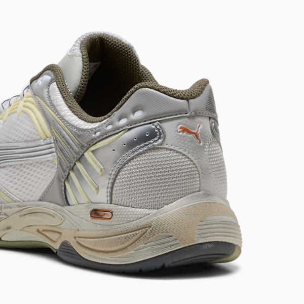 Silver PUMA trainer featuring mesh panels and an orange logo on the heel.