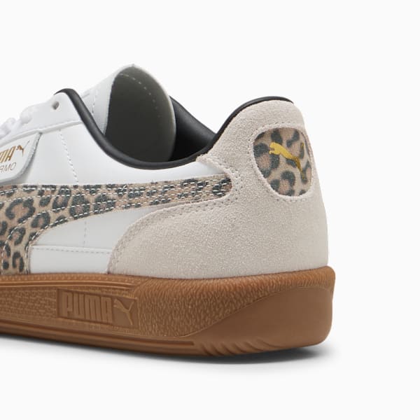 White PUMA trainer with leopard print detail and brown sole for women.