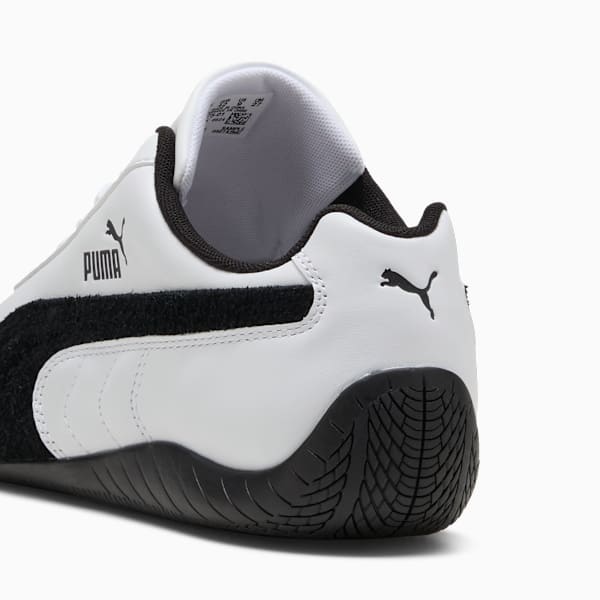 White PUMA adult trainer with a black formstrip and tire-patterned outsole.