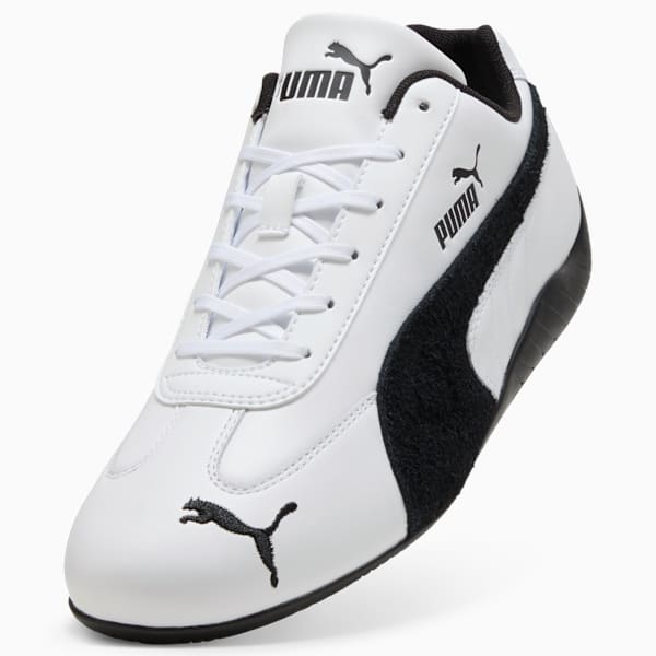 White PUMA trainers for adults with a black logo and stripe detail.