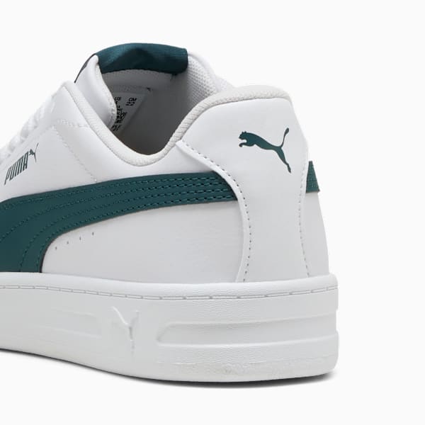 White PUMA trainer, adult, with dark green stripe and logo detail on the heel.