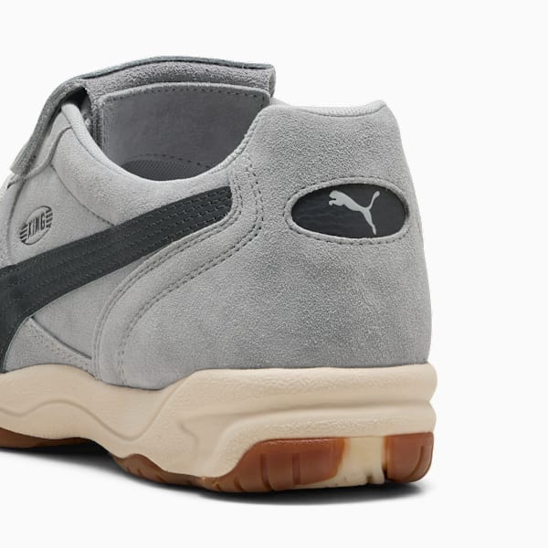 Grey PUMA trainer showing a dark stripe and logo on the heel.