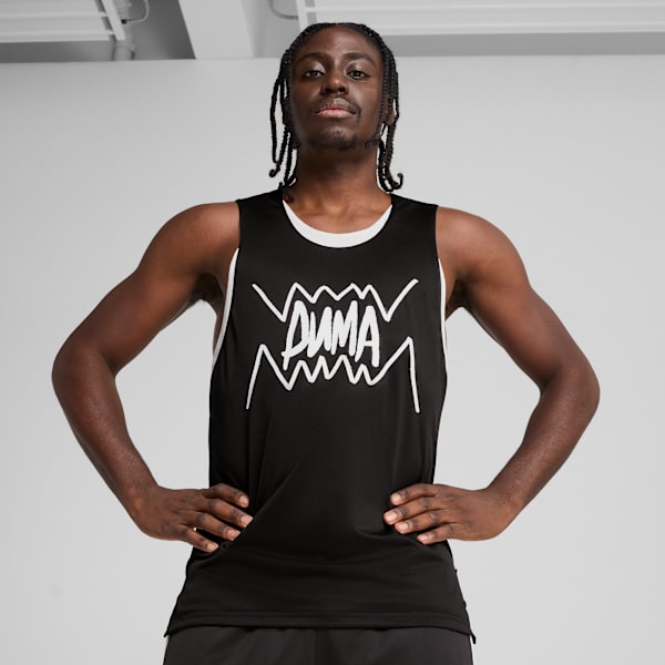 A model poses against a grey backdrop, wearing a black Puma branded sleeveless shirt.