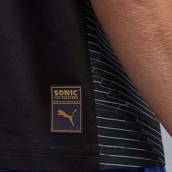 Close-up shows a black t-shirt with a Sonic the Hedgehog badge.