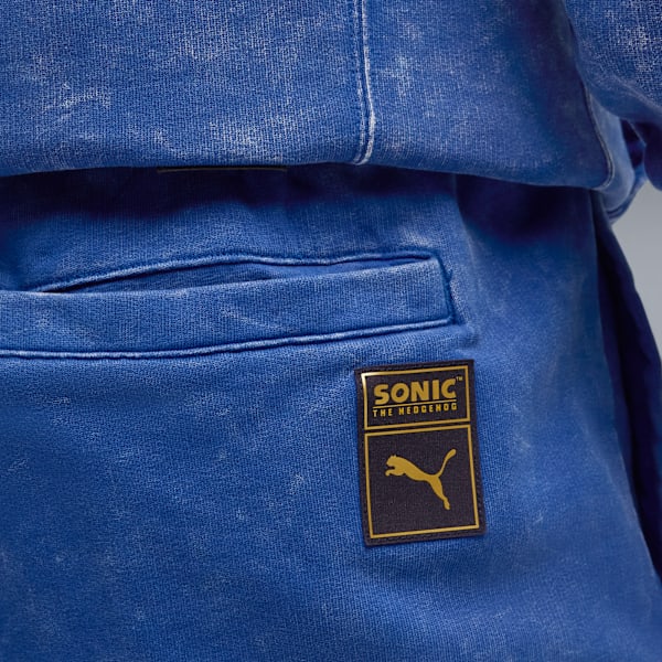 Close-up of blue trousers with a pocket and a Sonic the Hedgehog logo patch.