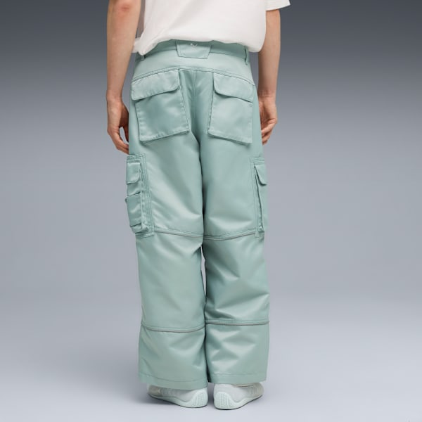 A model faces away on grey, wearing a white t-shirt and light-blue cargo trousers.