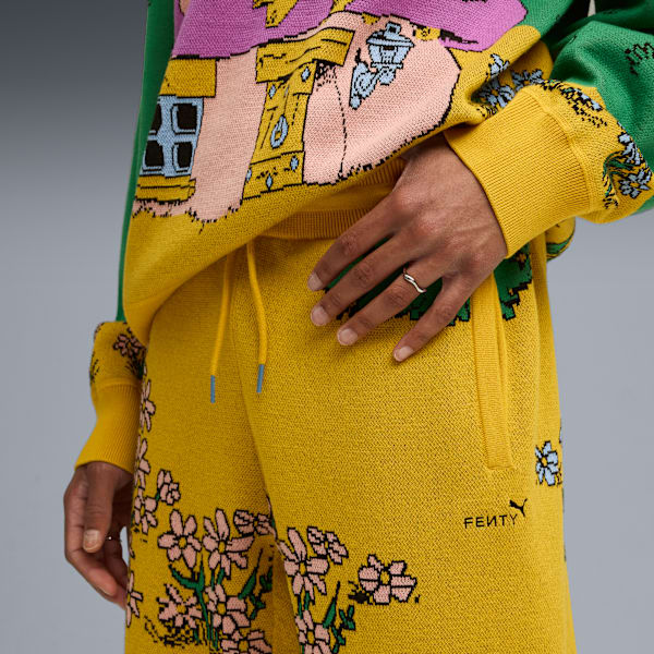 Against grey, a model wears a colourful patterned knitwear set with floral details.