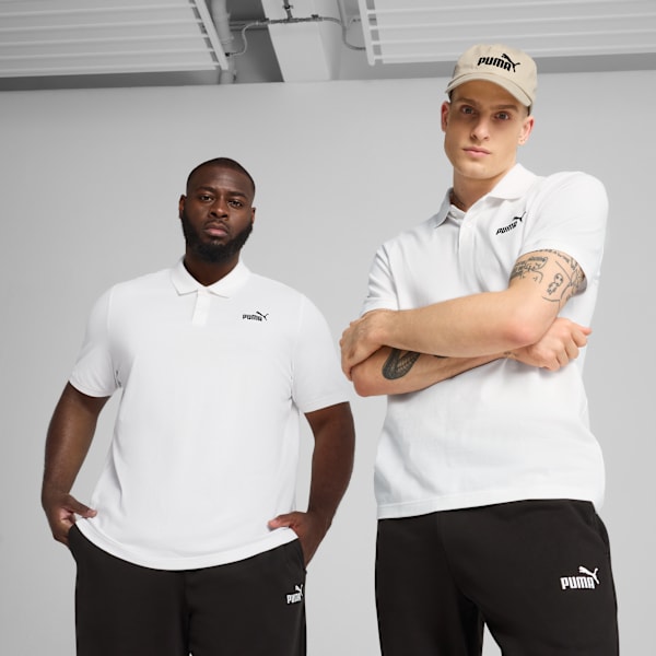 Two models pose against a grey backdrop, wearing white polo shirts and dark trousers.