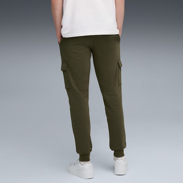 Against grey, a model stands wearing an olive cargo trousers, trainers and a white t-shirt.