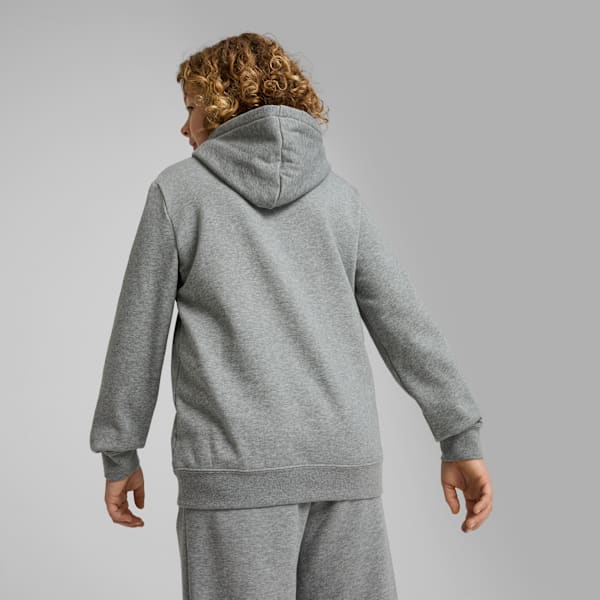 Seen from behind, a model faces left, wearing a grey hooded top and matching shorts.