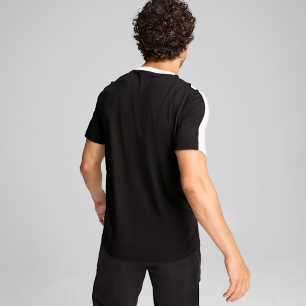 Model faces away against grey, wearing a black and white t-shirt and black bottoms.