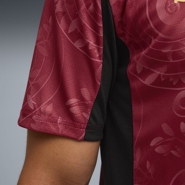 Close-up of a maroon patterned short-sleeved shirt with black side panel.