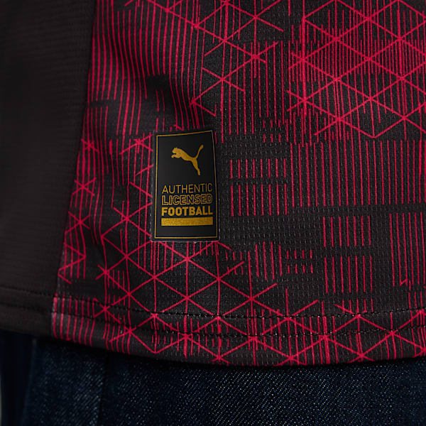 Close-up of a black and red patterned football shirt with an official Puma tag.