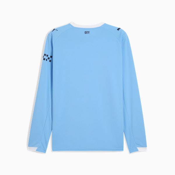 Light blue PUMA long-sleeve top with dark logos and checkered sleeve detail.