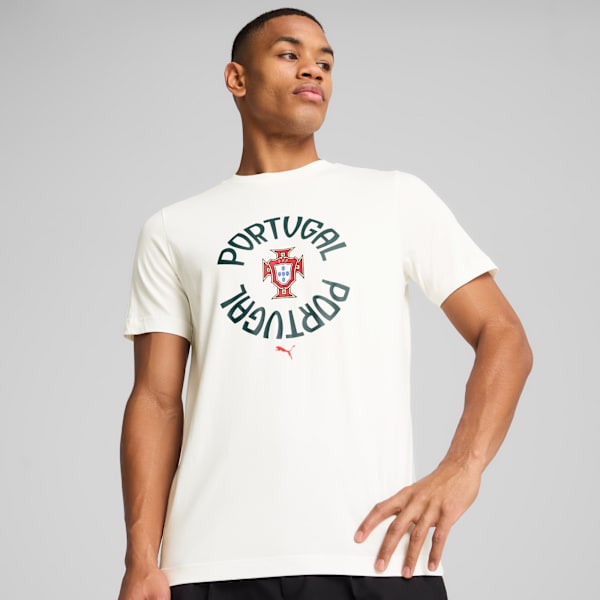 A model poses against a grey backdrop wearing a white Portugal logo t-shirt.