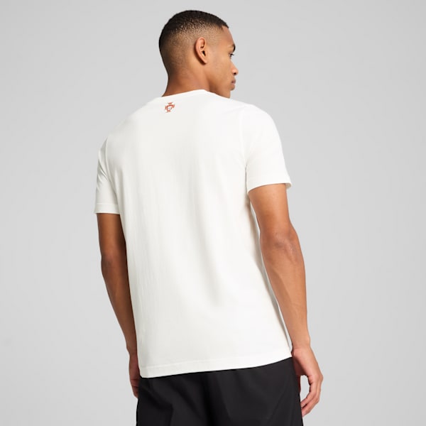 A model faces away on a grey backdrop, wearing a white t-shirt and black shorts.